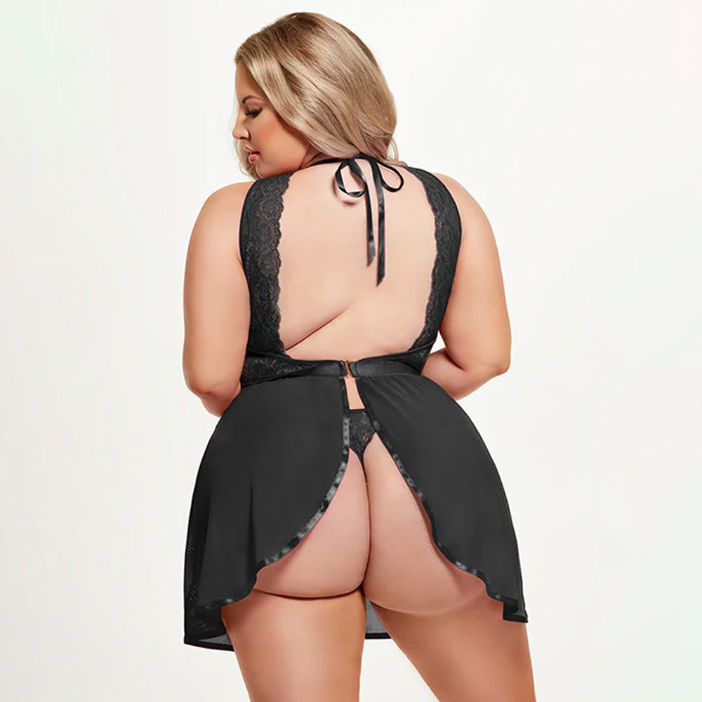 Back view of a plus-size model wearing a sheer black babydoll with a split-rear bottom to reveal the black thong underneath.