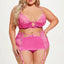 A curvy model wears a 3-piece pink bra, garter skirt and panty set with unlined sheer lace and opaque satin microfibre.