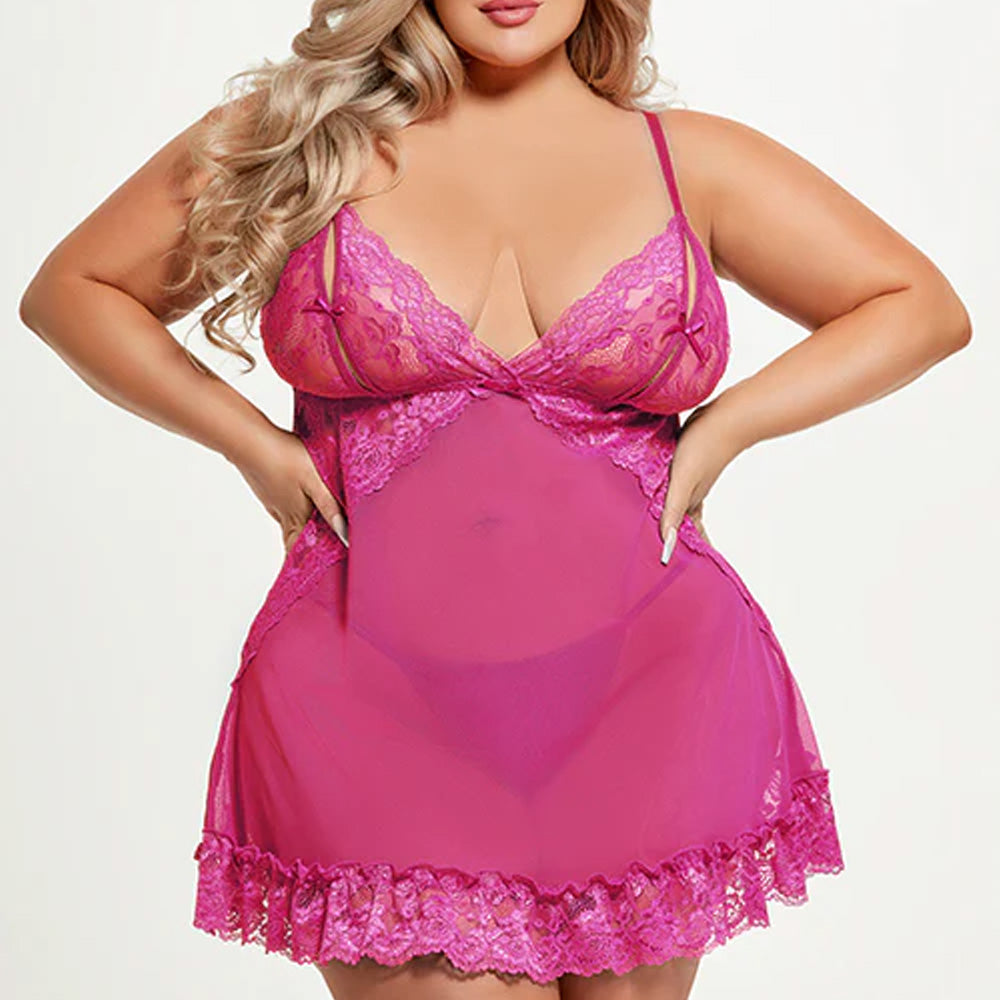 A curvy model wears a thong under a sheer pink mesh babydoll with vertical splits in the unlined lace cups and mini bowties.