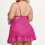 A back view of a plus-size lingerie model wearing a sheer pink mesh babydoll with a scalloped ruffle lace hem and a G-string.