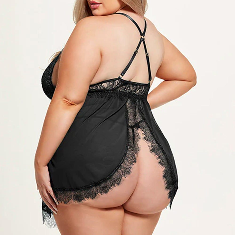 Back view of a plus-size model wearing an eyelash lace babydoll in black with flyaway split rear skirt and black G-string.