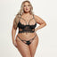 A curvy model wears a scalloped eyelash lace bra and panty in black with underwired cutout demi cups and a thong.
