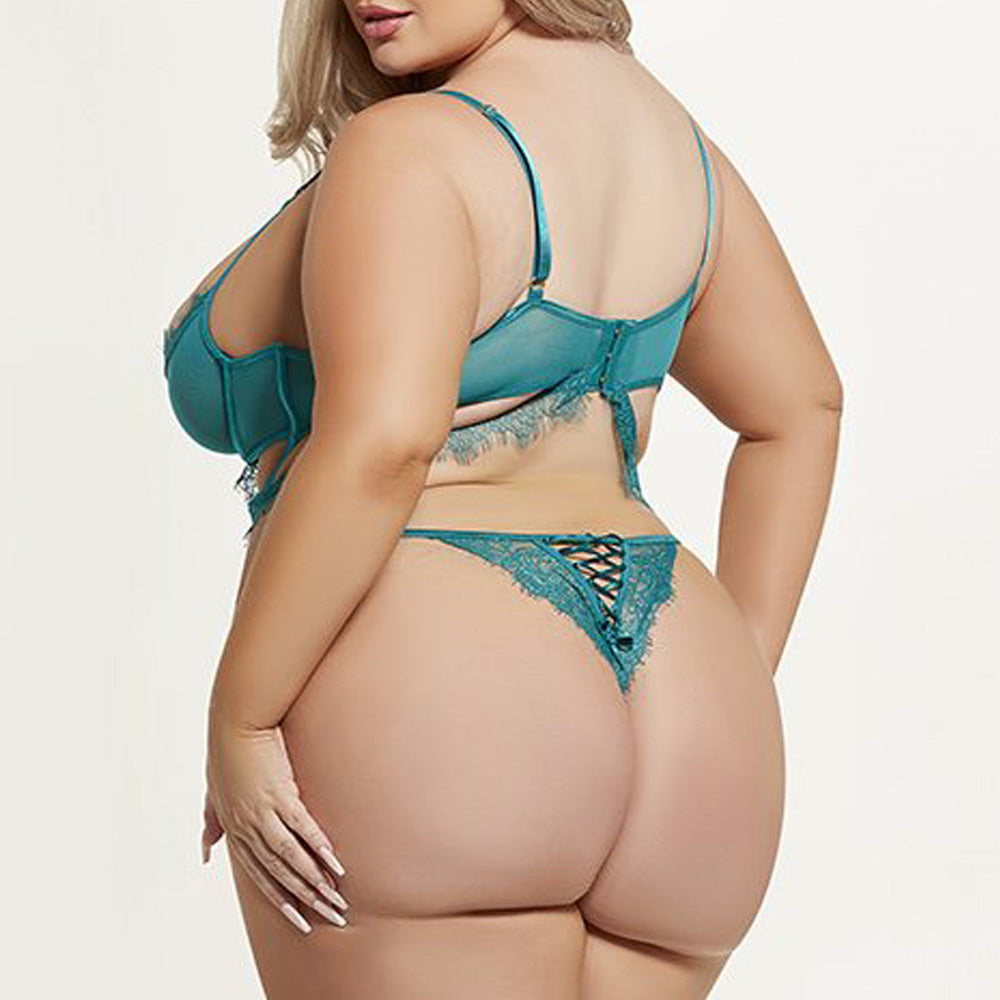 Back view of a curvy model wearing a teal eyelash lace bra and panty that features a criss-cross detail on the thong rear.
