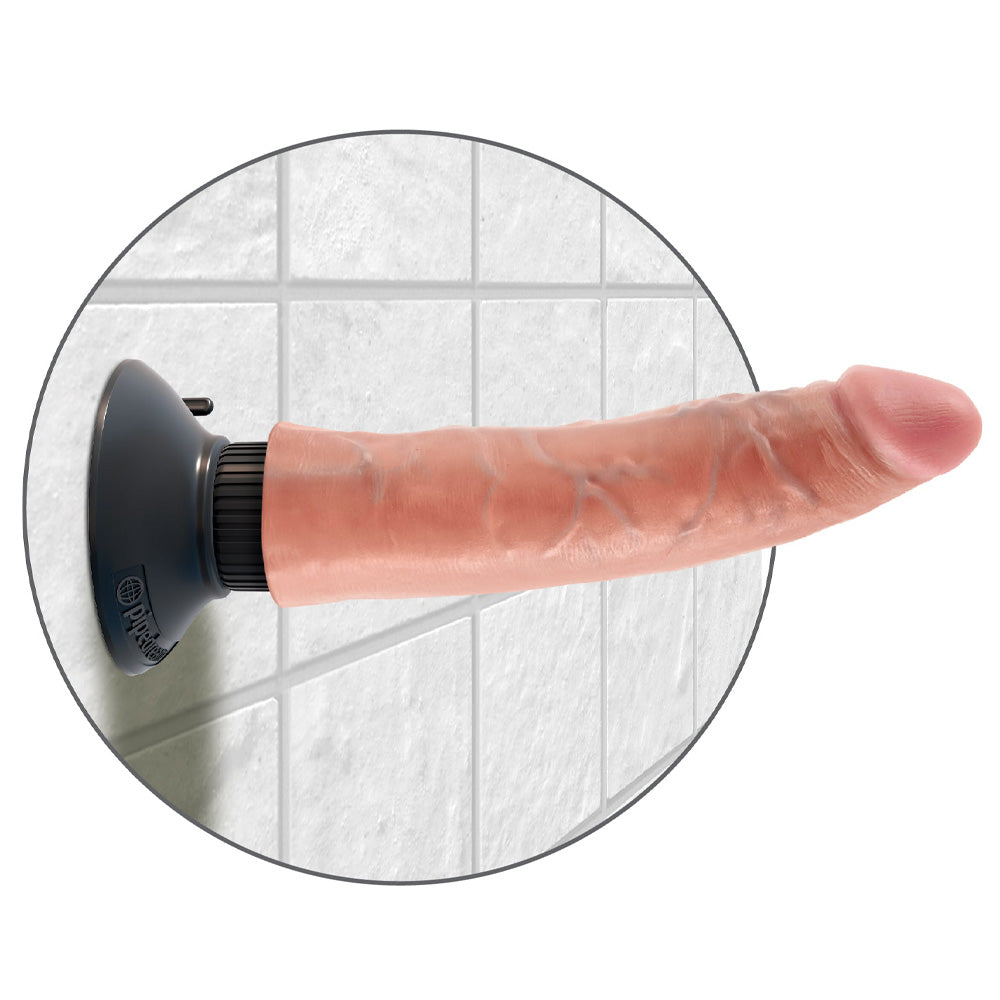 A realistic 7 inch vibrating dildo is shown attached to a shower wall with its suction cup base.