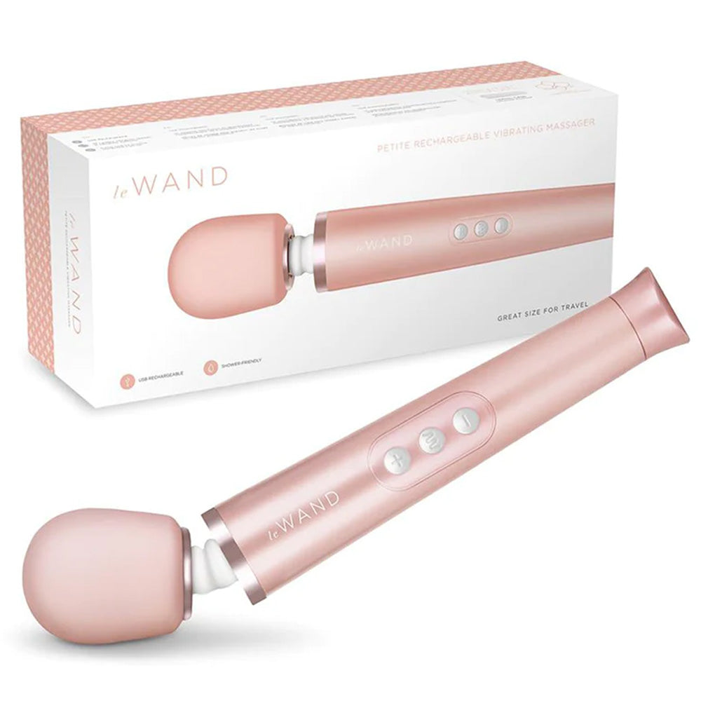 A Le Wand flexible recharbale wand massager lays next to its package. 