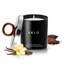 A Lelo vanilla and creme de cacao candle is lit and displayed with vanilla and cocoa beans next to it. 