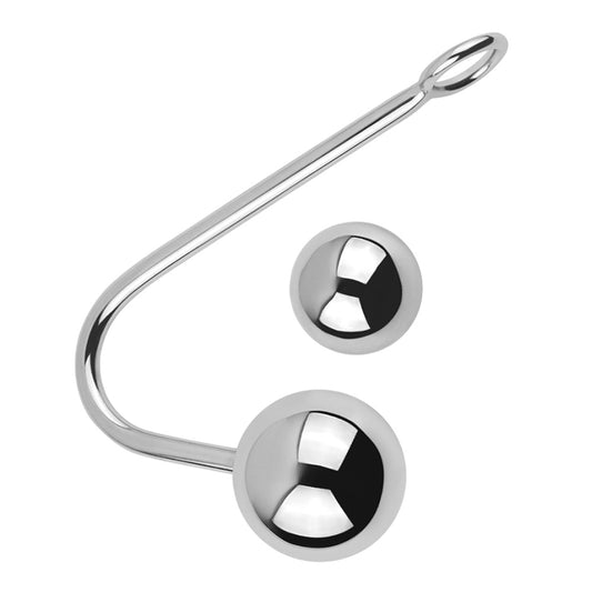 A metal anal hook lays on a white backdrop featuring two different sized interchangeable balls. 