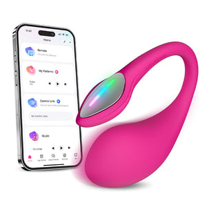 A hot pink app-controlled g-spot egg vibrator lays on a white backdrop next to a phone showcasing its app-compatibility. 