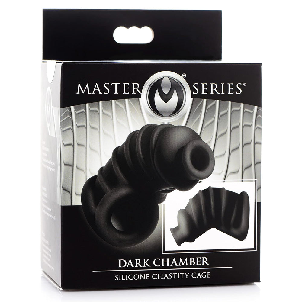 A box for the Master Series Dark Chamber black silicone chastity cage sits against a white backdrop.