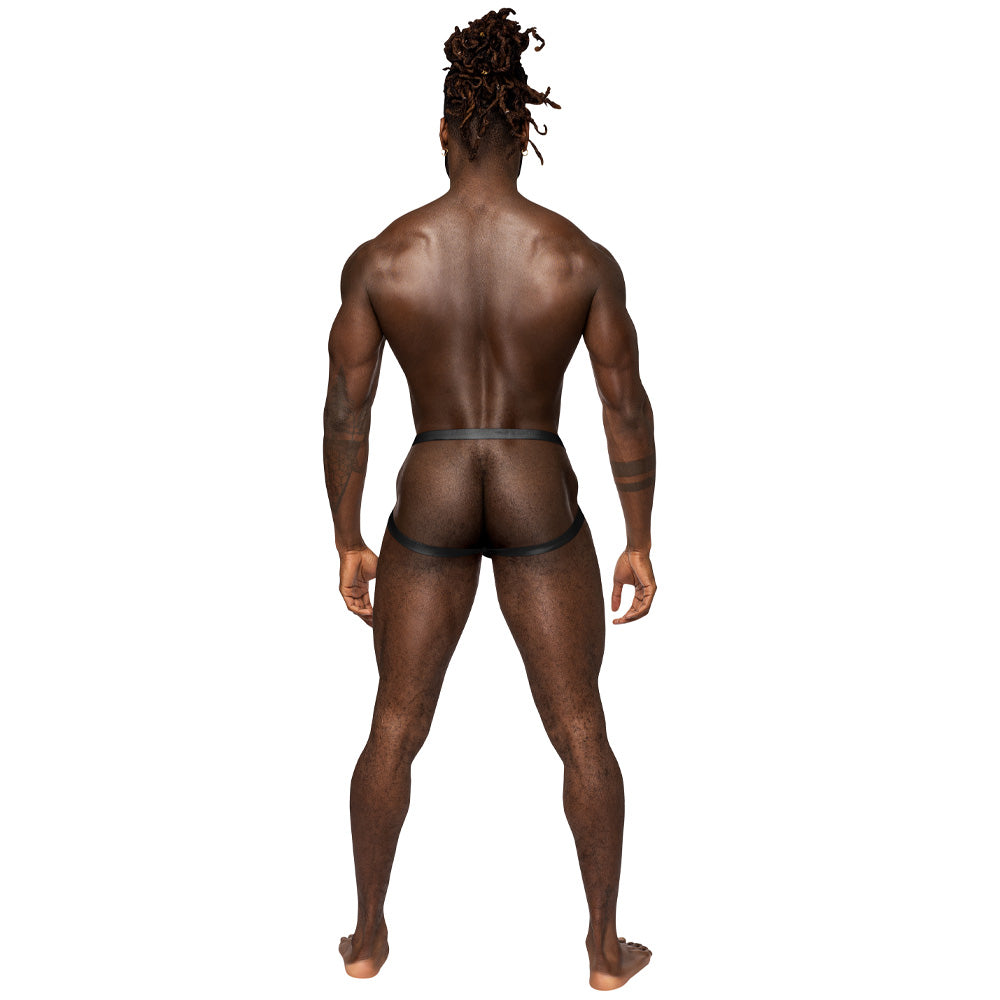 A rear shot of a male model posing in front of a white backdrop wearing a backless black jockstrap with satin straps.