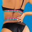 Close up back view of a model wearing a one shoulder top and panty set with gold swan hook closures.