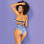 Back view of a model wearing a strapless crochet print wrap bandeau with medium-coverage denim print panties.