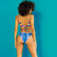 A back view of a model wearing a rainbow crochet print bralette that ties at the back with denim print panties.