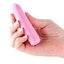 A hand model holds a mini silicone metallic pink bullet vibrator showcasing its one power button at the base. 