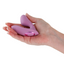A hand model holds a pink wearable G-spot vibrator showcasing its one power button on the base. 