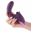 A hand model holds a curved thrusting clitoral rabbit vibrator in purple. 