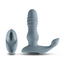 A grey remote control thrusting vibrating prostate stimulator stands next to its remote.