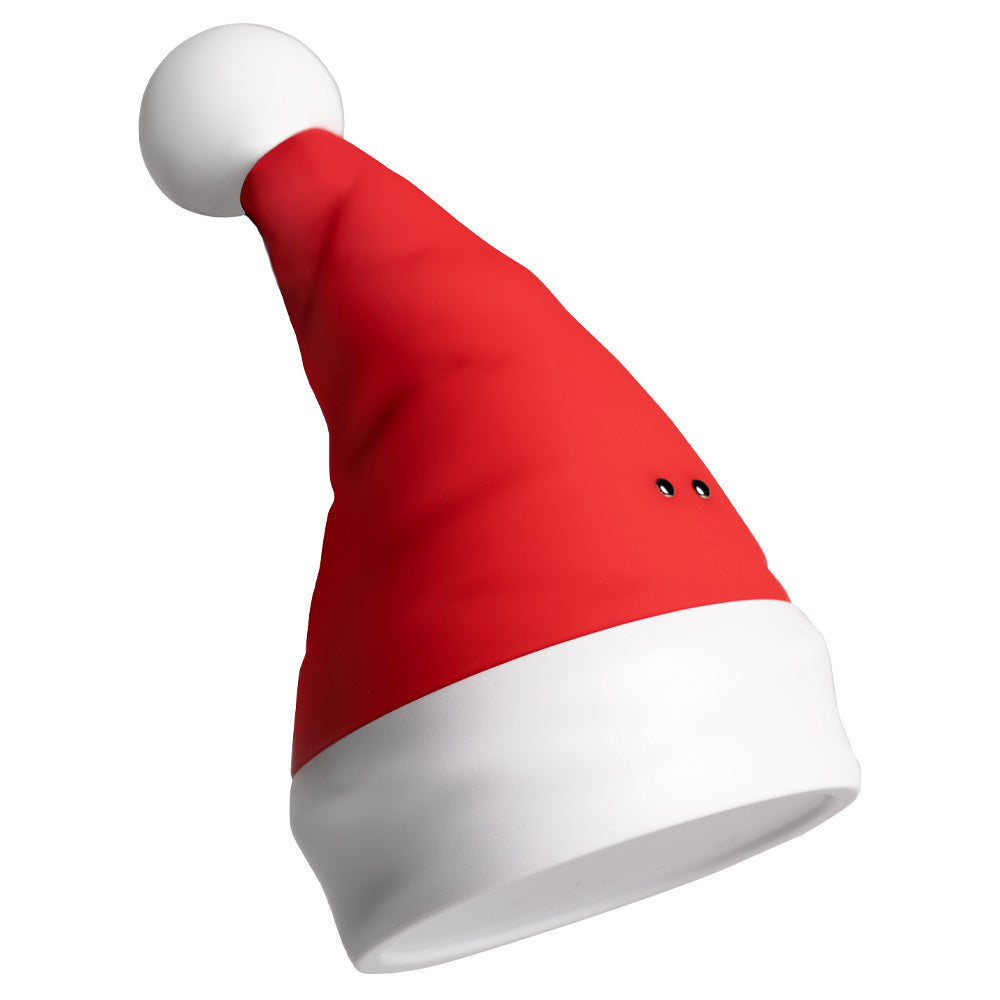 A red and white Santa hat-shaped clitoral vibrator with a white pompom shows its two magnetic charging points.