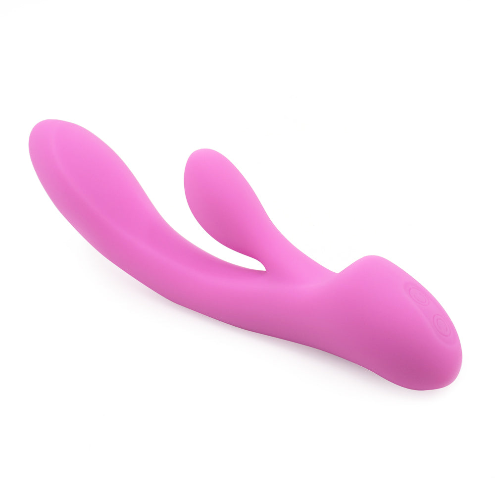 A light pink silicone rabbit vibrator with a curved G spot shaft lays on a white background showing its two control buttons. 