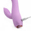 A close up back view of a rechargeable silicone rabbit vibrator's charging port with the USB cable plugged in.