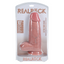 An extra thick realistic dildo sits in its clear packaging by Real Rock.