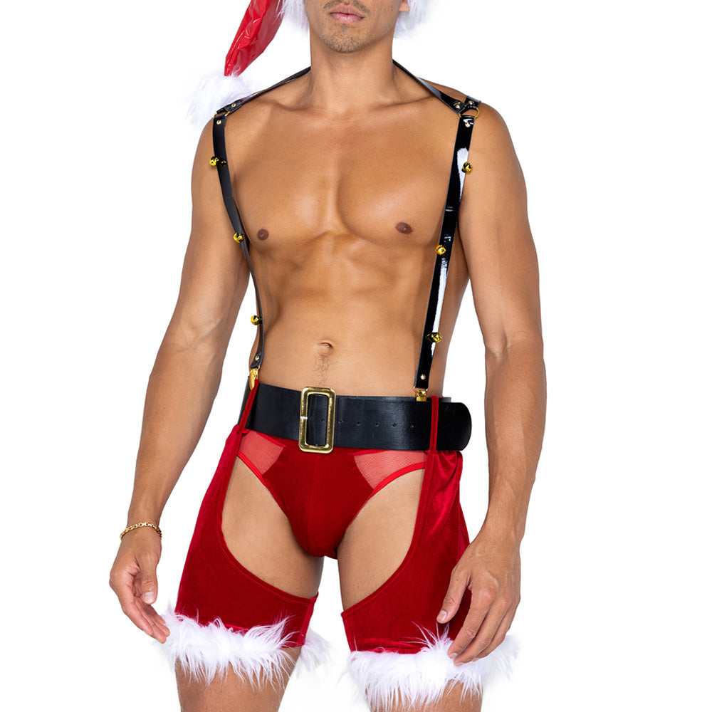 A topless male model wears a Saint Nicholas adult costume set with chaps, suspenders with gold bells, a belt, and briefs.