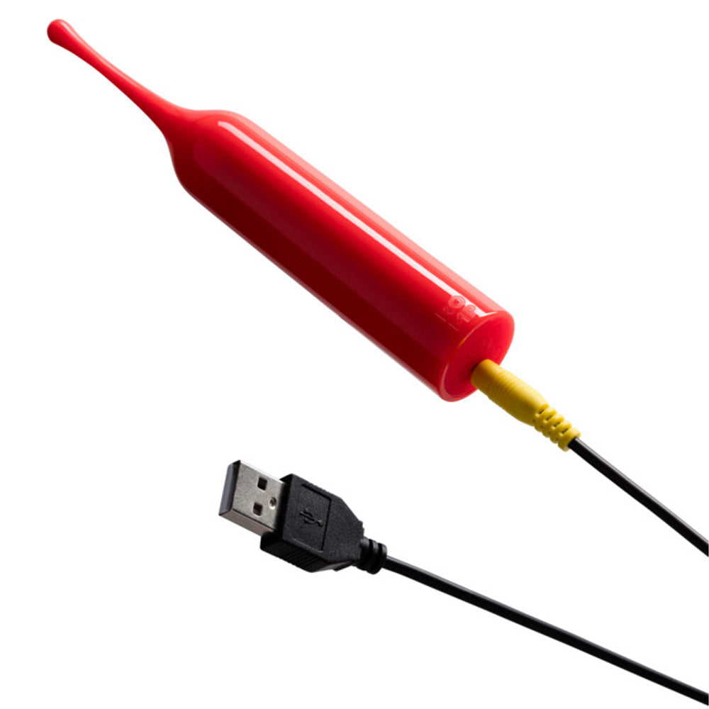 A red, cylindrical wand-shaped clitoral vibrator showcases its USB charging cord attached to the base.