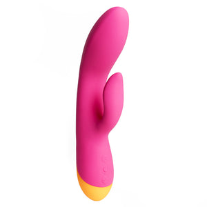 A pink and orange g-spot rabbit vibrator with a flexible head and shaft stands against a white backdrop. 