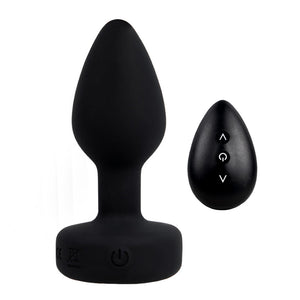 A large black remote control vibrating gem butt plug stands on a white backdrop next to its mini remote control with three buttons on it.