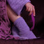 Close up of a model touching her sock covered foot with the Sexyland Embrace G Spot clitoral suction vibrator. 