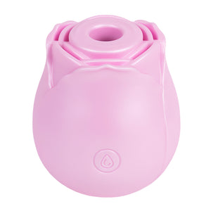 An iridescent pink rose shaped clitoral suction vibrator sits on a white backdrop. 