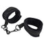 A pair of padded velcro handcuffs with detachable hook closures sits against a white backdrop. 