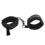 A pair of velvet soft velcro handcuffs attached by metal hook closures lays flat on a white backdrop. 