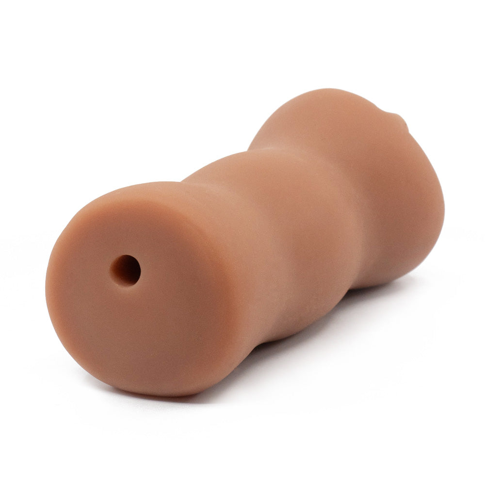 A back view of a realistic ebony pussy stroker with a ribbed texture shows the air hole, which sits against a white backdrop.