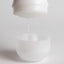 A Tenga gyro roller cup opens to reveal the pre-lubricated interior, with strands of lubricant clinging to the sleeve.