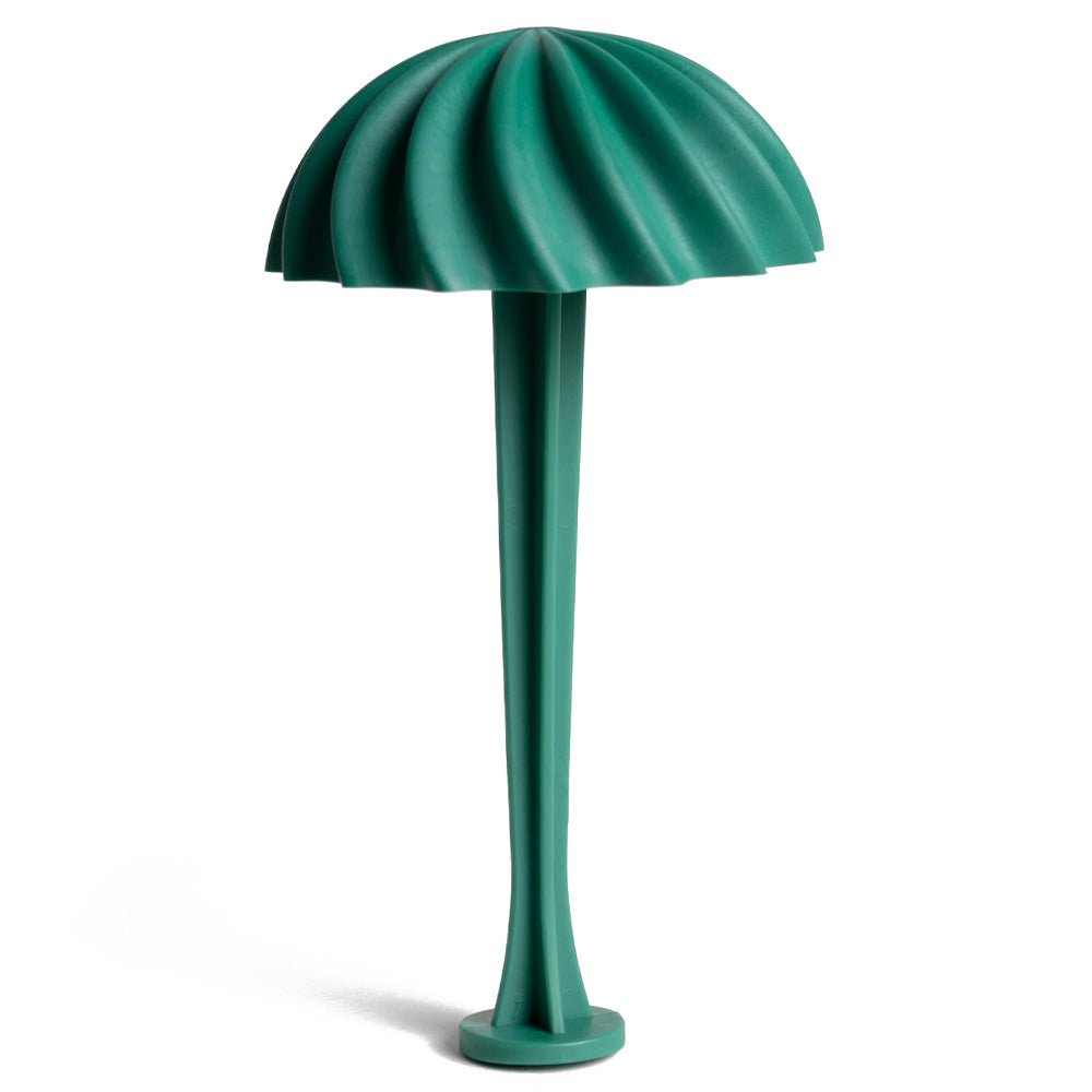 The green Tenga Flex suction masturbator cap and drying stand stands upright in an umbrella shape against a white backdrop.