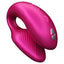 A shimmery pink silicone C-shaped couples vibrator shows the magnetic charging points on its external head.