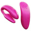 A glittery pink silicone couples vibrator sits next to its matching remote control.