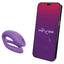 A We-Vibe Sync O app compatible couples vibrator in purple sits next to a phone.