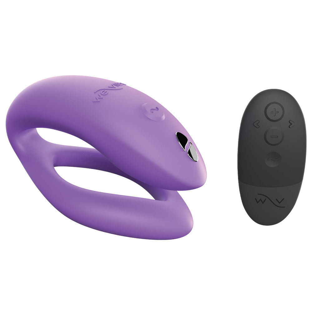 A We-Vibe Sync O secure fit app compatible couples vibrator in purple sits next to its black remote control.