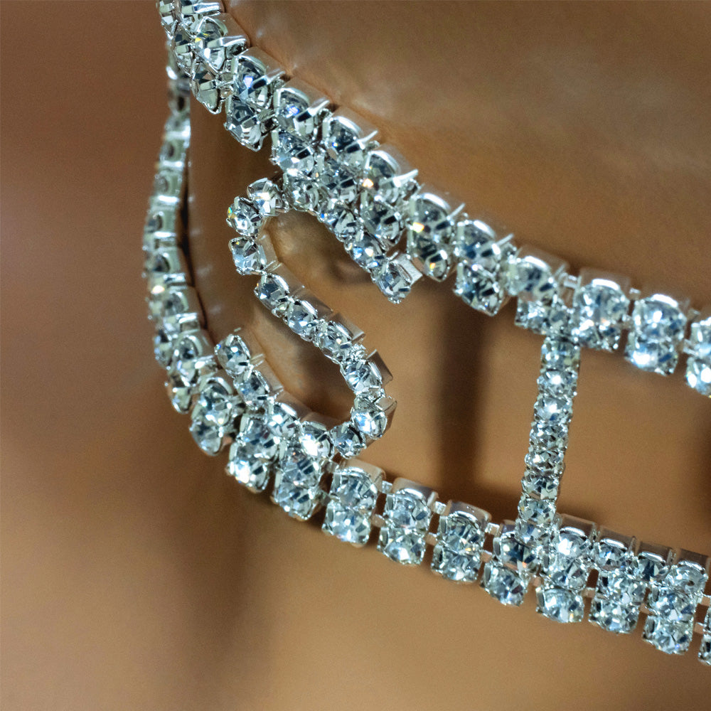 A close up shot of a silver choker that reads slut encrusted with diamanté’s