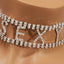 A close up shot of a silver choker that reads sexy encrusted with diamanté’s.