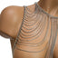 A close up of a mannequin wearing a silver draped shoulder body chain against a white backdrop.