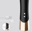 Back view of a mini bullet vibrator showcasing its magnetic charging points next to its charging cord. 