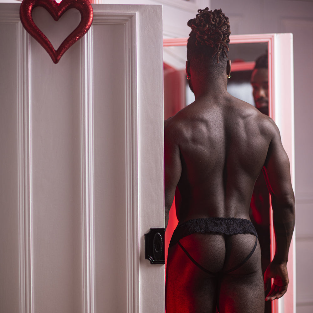 Male Power Sassy Lace Skirted Waistband Jock Strap blends a masculine jockstrap w/ soft feminine lace to accentuate your buns & package. Black. Editorial.