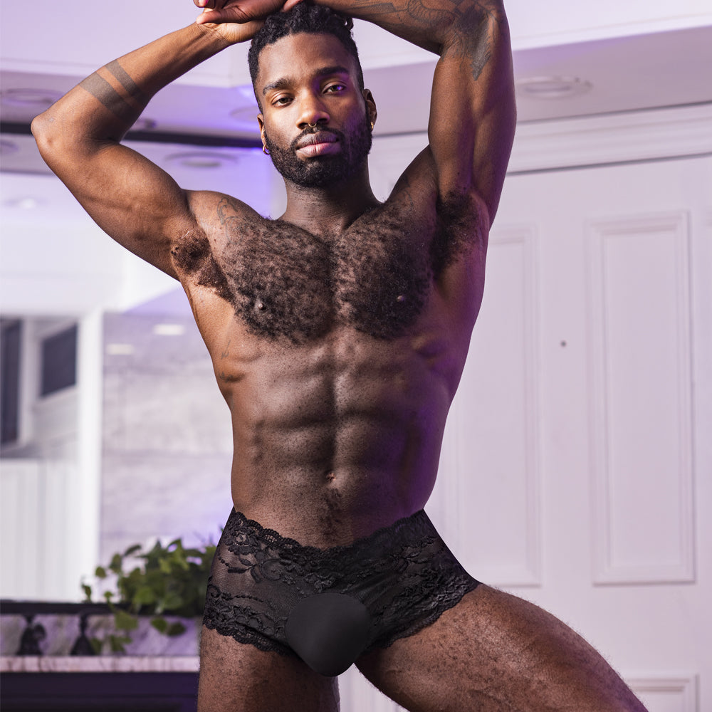 Male Power Sheer Sassy Lace Solid Pouch Mini Shorts are made from stretchy floral mesh w/ scalloped legs & waistband for a feminine touch. Black. Editorial.