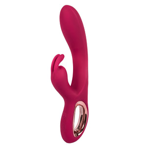 A pink rabbit vibrator with hollow handle & rabbit ears clitoral stimulator stands upright on a white background