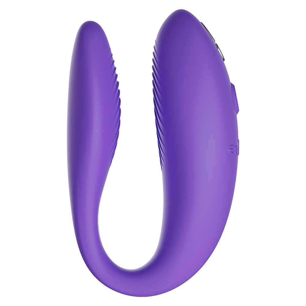 A left-side view of a purple We-Vibe Sync Go Couples Vibrator shows the ribbed texture on both heads.