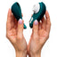 A model holds the Womanizer Liberty 2 Clitoral Stimulator and its magnetic cover in both their hands.