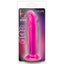 A hot pink harness compatible B Yours Sweet N' Small 6 inch dildo sits in its clear plastic packaging. 